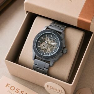 Fossil Modern Machine Automatic Men's Watch featuring a 44mm black dial, black stainless steel three-link strap, Japanese automatic movement, transparent front display, and exhibition case back.