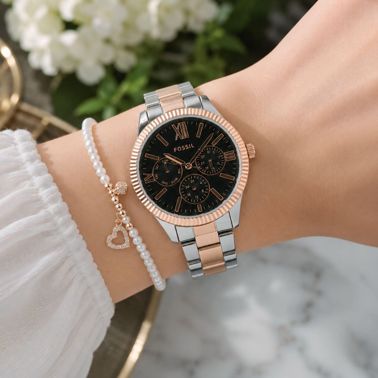 Fossil Rey Women’s Multifunction Watch featuring a black dial, day-date-24 hour display, elegant rose gold bezel, two-tone stainless steel bracelet, and reliable battery-operated movement. Fossil Rey Women's Multifunction Watch – Two-Tone Stainless Steel Bracelet with Black Dial & Rose Gold Bezel