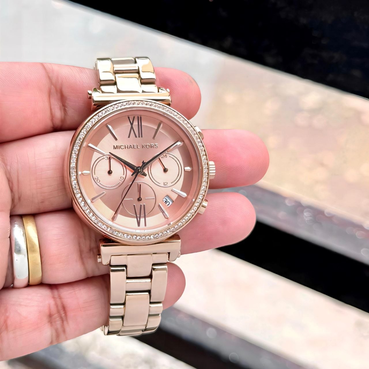 Michael Kors Sofie Women’s Watch – Rose Gold Crystal-Studded Bracelet with Date Display & Quartz Movement Michael Kors Sofie Women's Watch featuring an all rose gold stainless steel bracelet, crystal-studded bezel, date display, quartz movement, and elegant luxury-inspired styling.