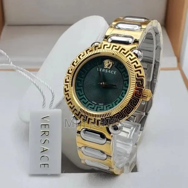Versace VE6I00423 women's watch featuring a luxurious gold dial, two-tone stainless steel bracelet, iconic Greek Key bezel design, mineral glass protection, and elegant luxury-inspired styling.